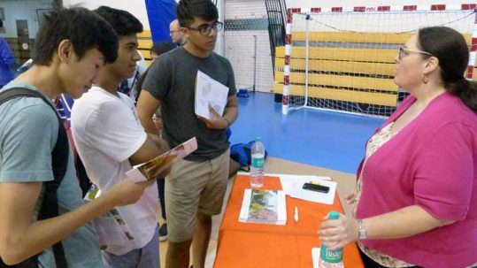 Woodstock students speak to a colllege representative at a college fair